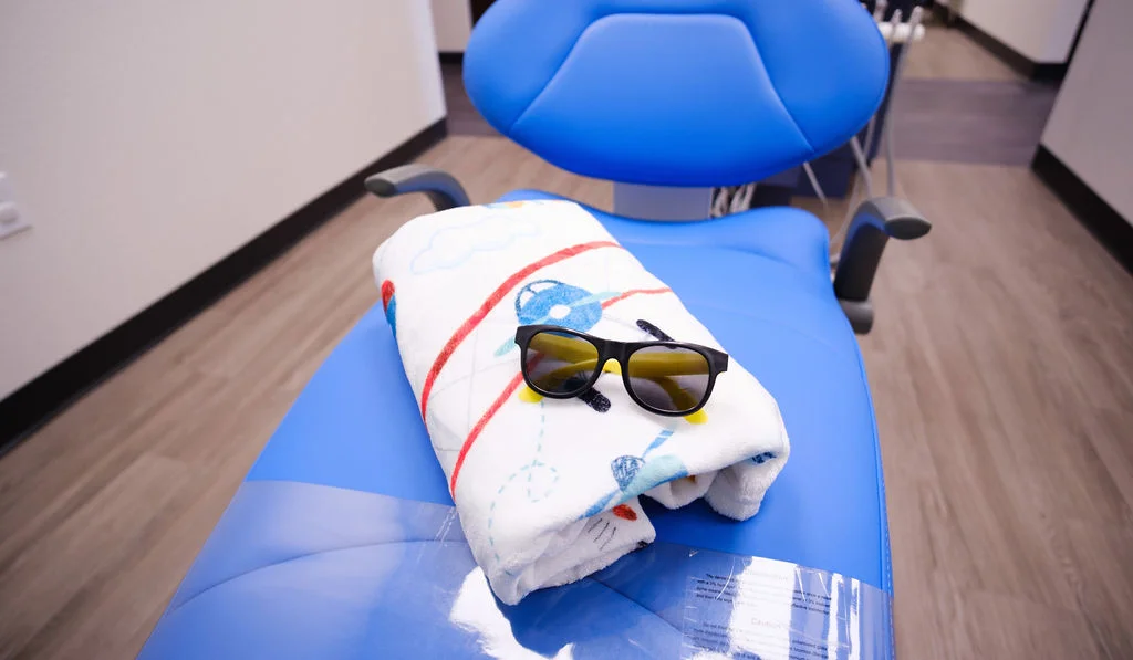comforting-blanket-glasses-on-patient-chair-in-office-aviator-pediatric-children's-dentistry-Watauga-TX